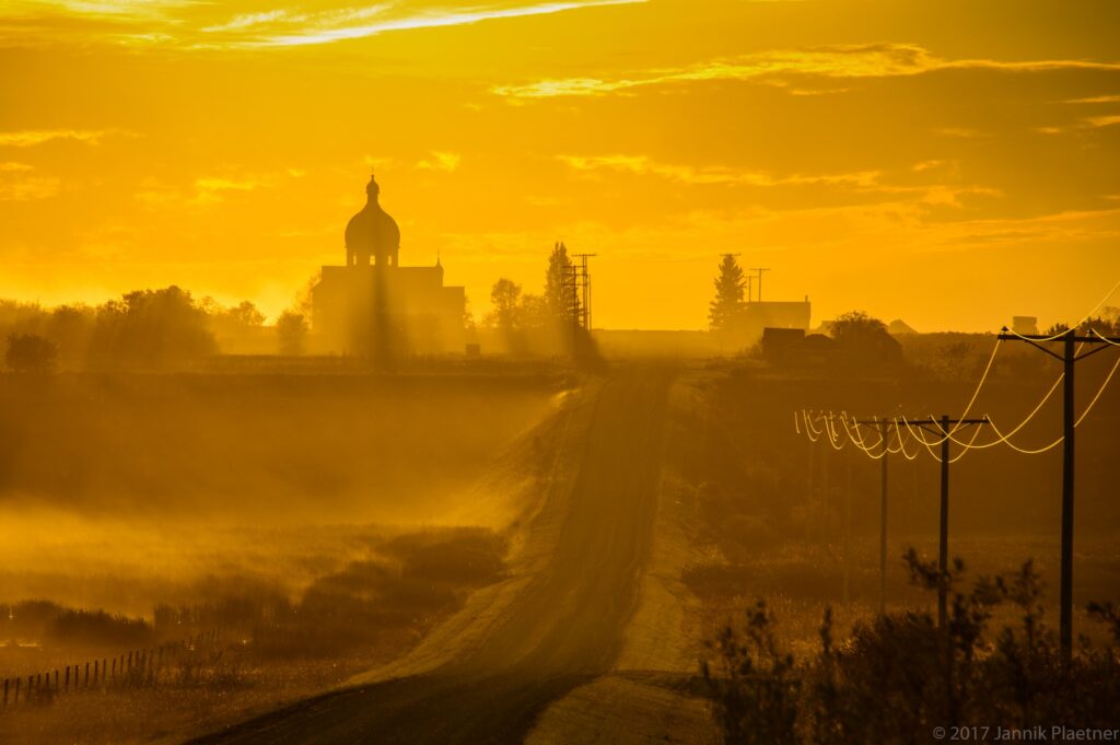 Church and road at Smuts Saskatchewan in golden light